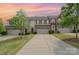 Inviting townhouse showcasing a well-manicured lawn and attached garages against a beautiful sky at 1849 Fleetwood Dr, Charlotte, NC 28208