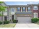 Well maintained two-story townhome features a brick facade and attached single car garage at 1849 Fleetwood Dr, Charlotte, NC 28208