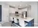 Stylish kitchen boasts an island with seating, modern appliances, and elegant lighting at 1849 Fleetwood Dr, Charlotte, NC 28208