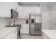 Bright kitchen with white cabinets, stainless steel refrigerator, and sleek countertops at 1849 Fleetwood Dr, Charlotte, NC 28208