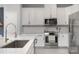 Well-lit kitchen features white cabinetry, stainless steel appliances, and stunning white quartz countertops at 1849 Fleetwood Dr, Charlotte, NC 28208