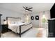 Bright main bedroom featuring a ceiling fan, wood floors, natural light, and modern decor at 1849 Fleetwood Dr, Charlotte, NC 28208