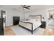 Spacious main bedroom showcasing hardwood floors, neutral walls, ceiling fan, and ensuite bath at 1849 Fleetwood Dr, Charlotte, NC 28208