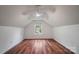 Finished attic with wood floors, ceiling fan, and a bright window at 1863 New Castle Dr, Fort Mill, SC 29707