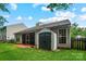 View of backyard with green grass, a storage shed, screened porch, and exterior of the home at 1863 New Castle Dr, Fort Mill, SC 29707