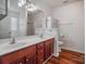 Bathroom with double sink vanity, white cabinets, and recessed lights at 1863 New Castle Dr, Fort Mill, SC 29707