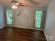 Comfortable bedroom with hardwood floors, natural light, and neutral-colored walls at 1863 New Castle Dr, Fort Mill, SC 29707