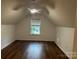 Finished attic bedroom with hardwood floors, natural light, and a ceiling fan at 1863 New Castle Dr, Fort Mill, SC 29707