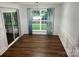 Bright dining room with hardwood floors, a sliding glass door, and decorative curtains at 1863 New Castle Dr, Fort Mill, SC 29707