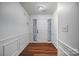 Welcoming entryway featuring pristine white walls, wood floors, and elegant wainscoting at 1863 New Castle Dr, Fort Mill, SC 29707
