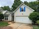 Charming home featuring a two-car garage, blue shutter and well-maintained landscaping at 1863 New Castle Dr, Fort Mill, SC 29707