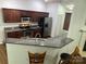 Modern kitchen with granite countertops, stainless steel appliances, and dark wood cabinets at 1863 New Castle Dr, Fort Mill, SC 29707