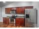 Kitchen with stainless steel appliances and dark wood cabinets at 1863 New Castle Dr, Fort Mill, SC 29707