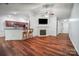 Open-concept living room with a fireplace, kitchen bar, and hardwood floors at 1863 New Castle Dr, Fort Mill, SC 29707