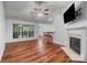 Spacious living room with hardwood floors, fireplace, tv and bar seating at 1863 New Castle Dr, Fort Mill, SC 29707