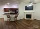 Open floor plan featuring a fireplace and a view of the kitchen with bar stool seating at 1863 New Castle Dr, Fort Mill, SC 29707