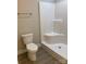 Bright bathroom featuring a toilet and tiled walk-in shower with grab bar at 1889 Oak Hollow Rd, Gastonia, NC 28054