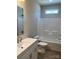 Bathroom with shower-tub combination, white vanity, and accentuating natural light at 1889 Oak Hollow Rd, Gastonia, NC 28054