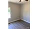 Comfortable bedroom featuring a large window providing ample light and wood-look floors at 1889 Oak Hollow Rd, Gastonia, NC 28054