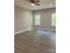 Spacious bedroom featuring great natural light, ceiling fan, and sleek wood-look floors at 1889 Oak Hollow Rd, Gastonia, NC 28054