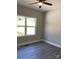 Bright bedroom with ceiling fan and large window offering a scenic outdoor view at 1889 Oak Hollow Rd, Gastonia, NC 28054