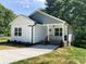 Charming home exterior with a welcoming front porch and well-manicured landscaping at 1889 Oak Hollow Rd, Gastonia, NC 28054