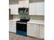 Well-lit kitchen features white cabinets, stainless steel microwave, and modern oven appliance at 1889 Oak Hollow Rd, Gastonia, NC 28054