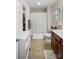 Neutral bathroom with shower, tile floor, and cherry vanity with white sink at 1988 Clear Brooke Dr, Kannapolis, NC 28083