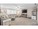 Inviting living room featuring a large sectional sofa, plush carpeting, and plenty of natural light from the windows at 1988 Clear Brooke Dr, Kannapolis, NC 28083