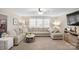 Cozy living room with a large sectional couch, soft carpet, and a view of the outside through bright windows at 1988 Clear Brooke Dr, Kannapolis, NC 28083