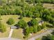 Expansive aerial view of a property featuring a house with surrounding green fields, mature trees, and paved roads at 2007 Green Peach Rd, Lancaster, SC 29720