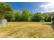 Spacious backyard showcasing a large grassy area and storage buildings at 2007 Green Peach Rd, Lancaster, SC 29720