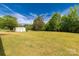 View of a large backyard with mature trees and a storage building at 2007 Green Peach Rd, Lancaster, SC 29720