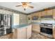 The kitchen is complete with stainless steel appliances, an island, and light wood cabinets at 2007 Green Peach Rd, Lancaster, SC 29720