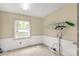 The laundry room has wainscoting, a large window, and plenty of room for sorting and folding laundry at 2007 Green Peach Rd, Lancaster, SC 29720