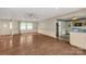 An open living room features wood floors, a ceiling fan, large windows, and connects to an adjacent kitchen at 2007 Green Peach Rd, Lancaster, SC 29720