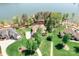 Expansive aerial shot of a lakeside property with a well-maintained lawn, mature trees, and waterfront access at 202 Timber Lake Dr, Troutman, NC 28166