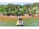 Aerial perspective of boat dock with canopy on a lakefront property at 202 Timber Lake Dr, Troutman, NC 28166