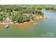 Scenic aerial view of a waterfront property featuring a private dock, lush trees, and lake access at 202 Timber Lake Dr, Troutman, NC 28166