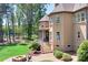 Exterior shot showing the home's backyard, a stone firepit and outdoor seating, and lake access at 202 Timber Lake Dr, Troutman, NC 28166
