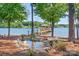 Backyard with a beautiful pond and waterfall feature, with access to a private wooden dock on the lake at 202 Timber Lake Dr, Troutman, NC 28166
