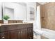 Bathroom features a dark vanity, a framed shower, and contemporary art, creating a spa-like experience at 202 Timber Lake Dr, Troutman, NC 28166