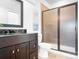 Bathroom features a modern vanity with a dark countertop, a framed shower, and decorative art at 202 Timber Lake Dr, Troutman, NC 28166