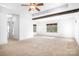 Expansive bedroom with tray ceiling, wood beams, neutral carpet, and bright windows offers a serene retreat at 202 Timber Lake Dr, Troutman, NC 28166