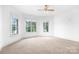Light-filled bedroom features neutral carpet, ample windows with views, and crisp white walls, creating a bright and airy space at 202 Timber Lake Dr, Troutman, NC 28166