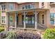 Covered porch with stone columns, wrought iron railings, and views of the lake at 202 Timber Lake Dr, Troutman, NC 28166