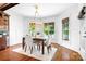 Bright dining room featuring hardwood floors, modern chandelier, and beautiful backyard views at 202 Timber Lake Dr, Troutman, NC 28166