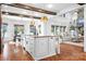 Open-concept kitchen with large island, stainless appliances, and wood beam accents, perfect for entertaining at 202 Timber Lake Dr, Troutman, NC 28166