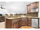 Cozy kitchenette with wooden cabinets, granite countertops, stone backsplash, and stainless steel appliances at 202 Timber Lake Dr, Troutman, NC 28166