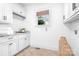 Clean laundry room with cabinets, sink, and counter space, blending functionality and style at 202 Timber Lake Dr, Troutman, NC 28166